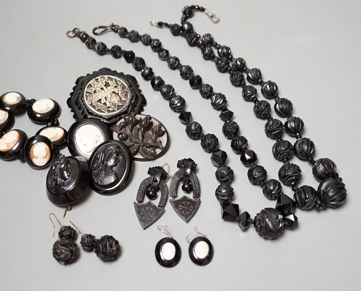 A collection of assorted jet jewellery, some with cameo, including two necklaces, five brooches, a bracelet and three pairs of earrings.